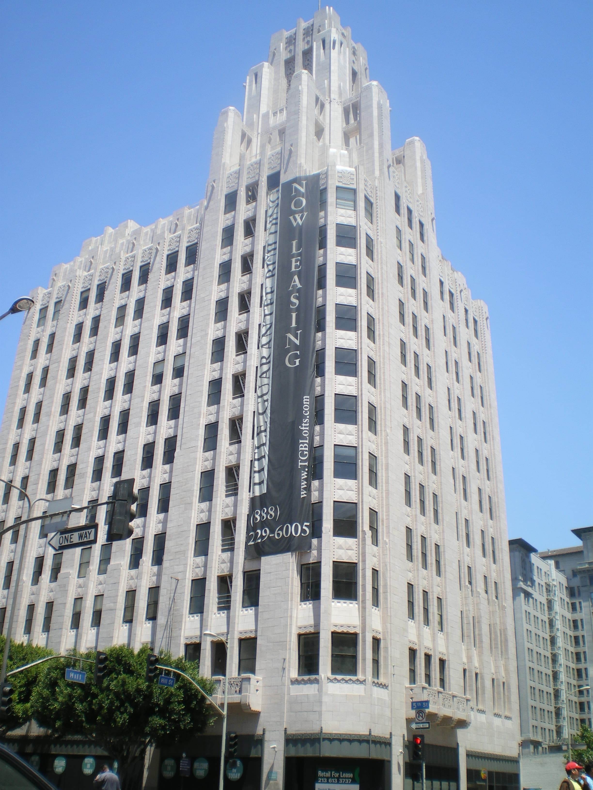 The Title Guarantee and Trust Company Building in Downtown Los Angeles with a leasing banner on its facade.